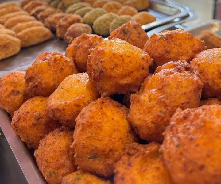 A tray of freshly fried salt cod fritters.