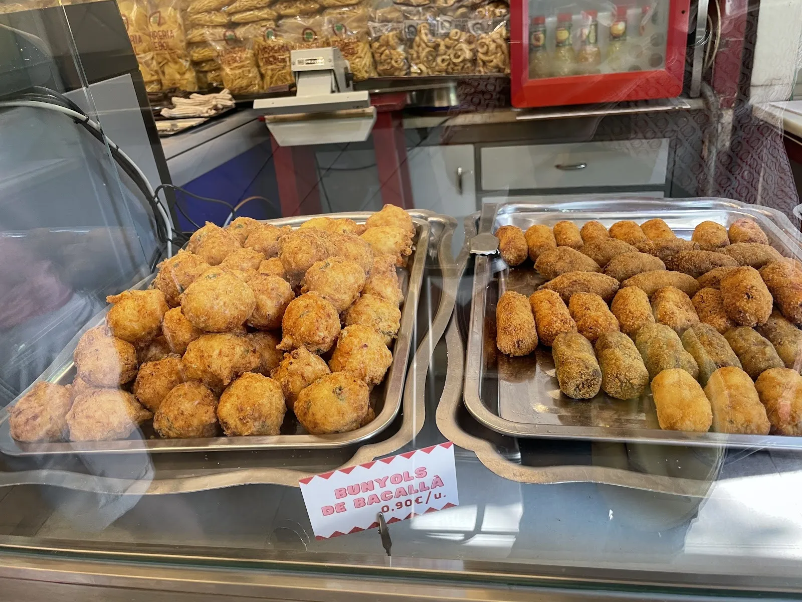 Trays of salt cod fritters on the counter.